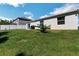 Expansive backyard with lush green grass, privacy fence, and patio, perfect for outdoor enjoyment at 151 Flatfish Ct, Poinciana, FL 34759