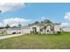 Beautiful single-story home with a manicured lawn and a spacious driveway leading to a garage at 151 Flatfish Ct, Poinciana, FL 34759