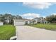 Lovely one story single Gathering home showcasing a large drive, attached garage and manicured lawn at 151 Flatfish Ct, Poinciana, FL 34759