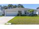 Charming single-story home featuring a well-maintained lawn and attached two-car garage at 151 Flatfish Ct, Poinciana, FL 34759