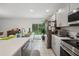 Bright kitchen features stainless steel appliances and view to backyard at 151 Flatfish Ct, Poinciana, FL 34759