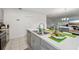 Kitchen island features stainless steel sink and view to living area at 151 Flatfish Ct, Poinciana, FL 34759
