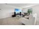 Bright living room with neutral walls, tile flooring, modern furniture, and a large flat-screen TV at 151 Flatfish Ct, Poinciana, FL 34759