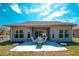 Backyard features a patio with chairs and table and green lawn at 153 Ventana Dr, Poinciana, FL 34759