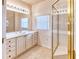 Bright bathroom featuring a large vanity with storage and a glass-enclosed shower at 153 Ventana Dr, Poinciana, FL 34759