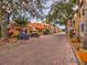 Picturesque community street featuring tile roofs, palm trees, and convenient golf cart parking at 153 Ventana Dr, Poinciana, FL 34759