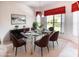 Elegant dining room featuring a glass-top table, modern chandelier, and designer decor at 153 Ventana Dr, Poinciana, FL 34759