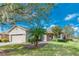 Inviting single-story home with manicured lawn, stone walkway, and neutral color palette at 153 Ventana Dr, Poinciana, FL 34759