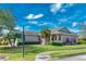 Charming single-story home featuring a well-maintained lawn and a covered porch entry at 153 Ventana Dr, Poinciana, FL 34759