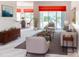 Bright living room with neutral furniture, decorative accents, and sliding glass doors to the patio at 153 Ventana Dr, Poinciana, FL 34759