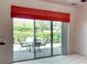 View of the outdoor patio and garden area from the bright and airy living room at 153 Ventana Dr, Poinciana, FL 34759