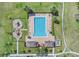 Aerial view of a community pool, playground, cabanas, and parking at 1578 Softshell St, St Cloud, FL 34771