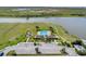 Aerial view of the community pool, playground, greenspace, parking, and nearby lake at 1578 Softshell St, St Cloud, FL 34771
