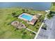 Aerial view of the community pool, playground, parking lot, and greenspace at 1578 Softshell St, St Cloud, FL 34771