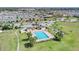 Aerial view of the community pool, playground, greenspace, and surrounding homes at 1578 Softshell St, St Cloud, FL 34771