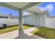 Backyard image of a covered patio area with grass, an AC unit, and a fence at 1578 Softshell St, St Cloud, FL 34771