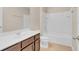 Bathroom featuring double sinks, dark wood cabinets, and a shower/tub combination at 1578 Softshell St, St Cloud, FL 34771