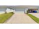Exterior shot shows townhome driveways, lawns, and garages in a community at 1578 Softshell St, St Cloud, FL 34771