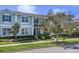 Beautiful two-story blue townhome with manicured lawn, trees, and clear sky at 1578 Softshell St, St Cloud, FL 34771