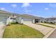 Exterior view of townhomes shows well-maintained lawns and driveways, and attached garages at 1578 Softshell St, St Cloud, FL 34771