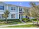 Charming blue two-story townhome with well-maintained landscaping and a welcoming entrance at 1578 Softshell St, St Cloud, FL 34771