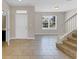 Inviting foyer featuring tile floors, staircase, and a bright window view for a welcoming entrance at 1578 Softshell St, St Cloud, FL 34771