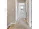 Upstairs hallway featuring neutral carpet, leading to bedrooms and bathrooms at 1578 Softshell St, St Cloud, FL 34771