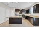 Well-equipped kitchen with granite countertops, stainless steel appliances, and dark cabinetry at 1578 Softshell St, St Cloud, FL 34771