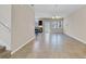 Open living area with tile flooring, chandelier, and access to the kitchen and outdoor patio at 1578 Softshell St, St Cloud, FL 34771