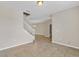 Open floor plan with tile flooring, staircase, and ample natural light at 1578 Softshell St, St Cloud, FL 34771