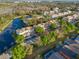 An aerial view highlights a pondside community with lush landscaping and convenient parking at 1717 Retreat Cir, Clermont, FL 34714