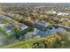 An aerial view of a community with ponds, mature trees, and manicured lawns at 1717 Retreat Cir, Clermont, FL 34714
