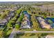 A high-angle aerial view of a multi-Gathering community with manicured lawns and nearby pond at 1717 Retreat Cir, Clermont, FL 34714