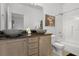 Well-lit bathroom with double vessel sinks, granite countertops, and shower-tub combo at 1717 Retreat Cir, Clermont, FL 34714