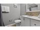 Bathroom with shower, toilet, sink, vanity with a modern countertop, and decor at 1717 Retreat Cir, Clermont, FL 34714