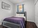 Bedroom with dark wood floors, a queen bed, and a closet, designed for rest and storage at 1717 Retreat Cir, Clermont, FL 34714