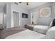 Cozy bedroom showcasing twin beds, a wall-mounted TV, closet, and neutral decor at 1717 Retreat Cir, Clermont, FL 34714