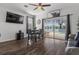 Cozy dining area with pool view, ceiling fan and dark hardwood flooring at 1717 Retreat Cir, Clermont, FL 34714