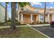 Charming two-story townhome featuring a covered entry and nicely manicured lawn at 1717 Retreat Cir, Clermont, FL 34714
