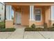 Inviting front porch with decorative columns and well-maintained landscaping at 1717 Retreat Cir, Clermont, FL 34714