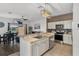 Bright kitchen features stainless steel appliances, shaker style cabinets, and granite countertops at 1717 Retreat Cir, Clermont, FL 34714