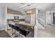 Kitchen with an island, white cabinets, stainless steel appliances, barstool seating and pendant lighting at 1717 Retreat Cir, Clermont, FL 34714