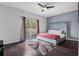 Stylish main bedroom with a ceiling fan and a private balcony entrance at 1717 Retreat Cir, Clermont, FL 34714