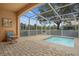 A screened-in patio with a small pool and comfortable seating overlooks a verdant landscape at 1717 Retreat Cir, Clermont, FL 34714