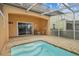 A condo with a screened-in patio area featuring a step-in pool and outdoor seating at 1717 Retreat Cir, Clermont, FL 34714