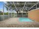 A condo with a screened-in patio area featuring a step-in pool and access to a pond at 1717 Retreat Cir, Clermont, FL 34714