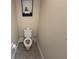 Bathroom featuring a toilet, framed artwork, neutral tile flooring and decor at 199 Macaulays Cv, Haines City, FL 33844