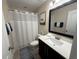 Bathroom featuring a single sink vanity, a shower with a white shower curtain, and neutral decor at 199 Macaulays Cv, Haines City, FL 33844