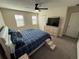 Bright bedroom featuring a bed, ceiling fan, and a dresser with a TV, creating a comfortable and inviting space at 199 Macaulays Cv, Haines City, FL 33844