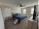 Bedroom with a large bed, a ceiling fan, and windows providing ample natural light at 199 Macaulays Cv, Haines City, FL 33844